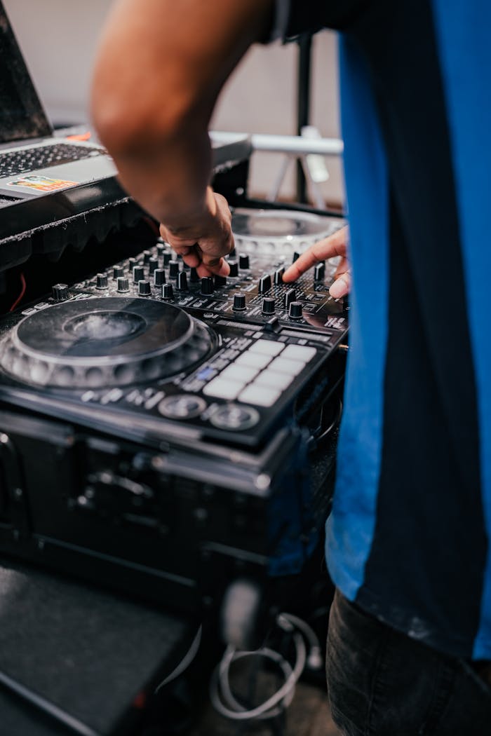 Offerings Close-up of a DJ mixing music with equipment, setting the club vibe.
