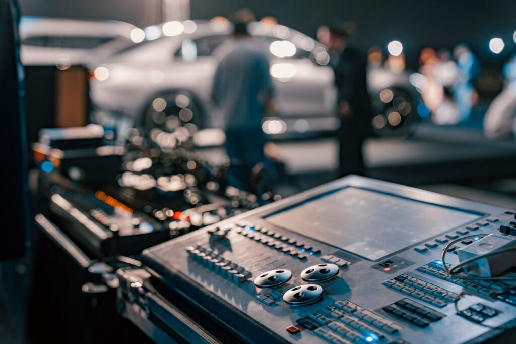 The Art of Drawing Readers In: Your attractive post title goes here Close-up of a sound mixer at a lively indoor event with blurred people in the background.