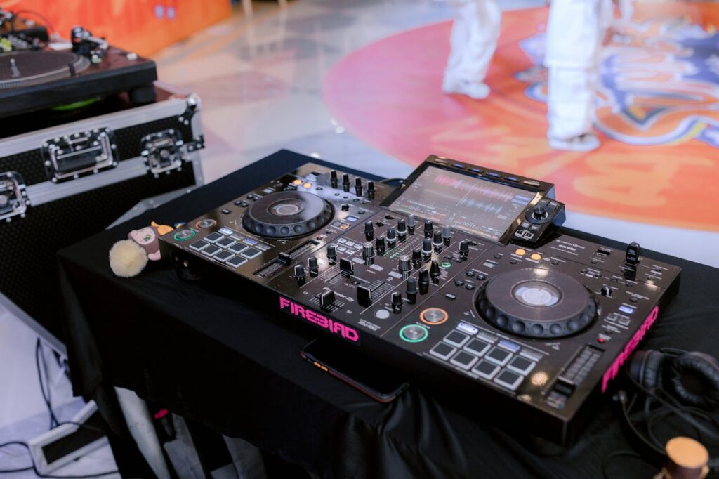 Mastering the First Impression: Your intriguing post title goes here Close-up of professional DJ equipment setup, highlighting a digital mixer and turntable at an indoor event.